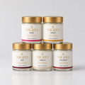 Five NIGEO cream deodorant jars in a pyramid, the complete range