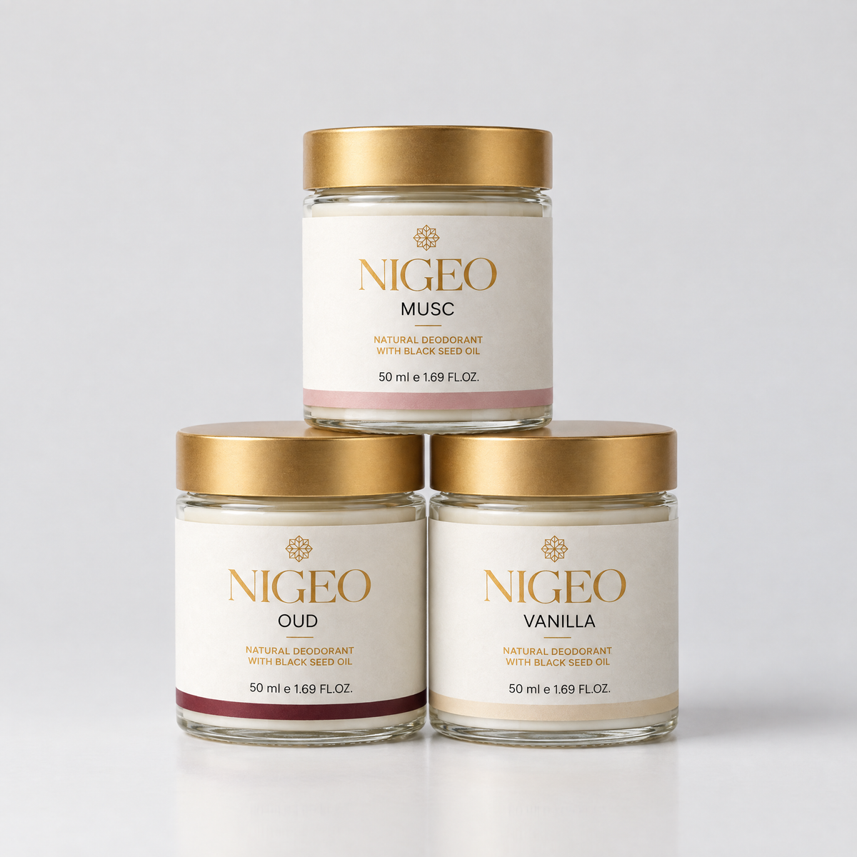 Three NIGEO cream deodorant jars in a pyramid, Oud, Musc and Vanilla